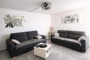 a living room with two couches and a table at Studio cosy, Centre Port, Piscine, proche plage in Cap d'Agde