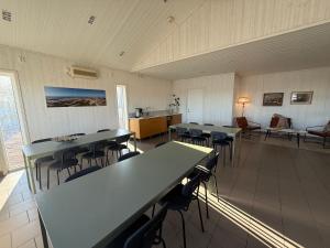 a classroom with tables and chairs in a room at Open Water Lodge Smögen in Smögen