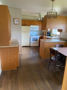 a kitchen with wooden cabinets and a table with chairs at Home sweet home in Thunder Bay