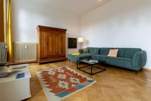 a living room with a couch and a coffee table at Fürstlich Wohnen am Circus mit Blick zur Granitz in Putbus +43 photos