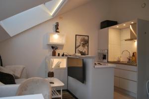 a kitchen with a sink and a counter top at Penthouse Studio in Stockholm