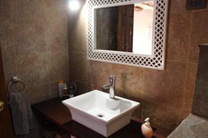 a bathroom with a white sink and a mirror at Casa Garces in San Pedro de Atacama +26 photos