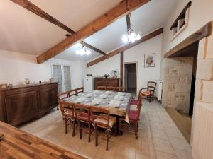 a kitchen and dining room with a table and chairs at Gîte de La Rev'rie in Montalembert