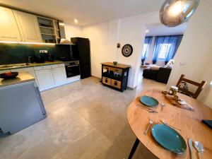 a kitchen and living room with a wooden table at Domov na cestě in Rousovice