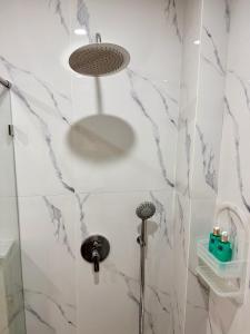 a bathroom with a shower with a shower head at SOHO Rooftop 360 Sunset Edition in Essaouira +28 photos