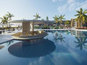 a resort with a pool with tables and chairs and palm trees at Flat em Porto life Resort in Porto De Galinhas