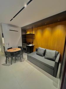 a living room with a couch and a table at Flat em Porto life Resort in Porto De Galinhas +6 photos