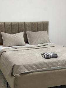 a bed with a blanket and pillows on it at Hotel grosvenor in Saint-Arnaud +3 photos