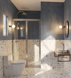 a bathroom with a shower and a toilet and a sink at Under The Palm Tree - Boutique Stay Experience in Áno Meriá +75 photos