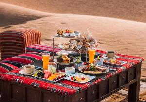 a tray of food on a table on the beach at Amazing Luxury Camp in Merzouga