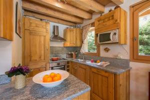 a kitchen with a bowl of oranges on a counter at Chalets Zaria Garden Fireplace near Ski Lift - Happy Rentals in Argentiere