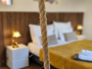 a close up of a bedroom with a bed at A Casa do Comandante - Piscina e Jardim in Lagoa