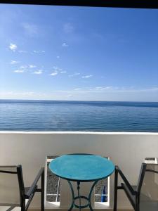 a table and chairs on a balcony overlooking the ocean at Blue Sea in Ierapetra