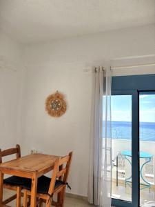 a dining room with a table and a view of the ocean at Blue Sea in Ierapetra