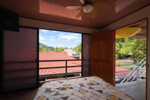 a bedroom with a bed and a view of a balcony at Good Vibes Apartments in Talamanca +30 photos