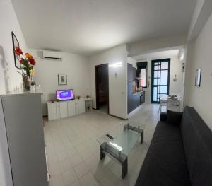 a living room with a couch and a table at Casa Jaya Taormina in Taormina