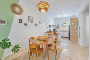 a kitchen and dining room with a table and chairs at Boho Oasis by the Beach in San Juan +14 photos