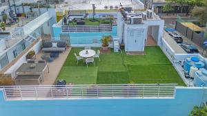 an aerial view of a house with a yard at Boho Oasis by the Beach in San Juan