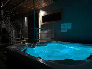a hot tub with blue water in a room at Good Vibes Apartments in Talamanca