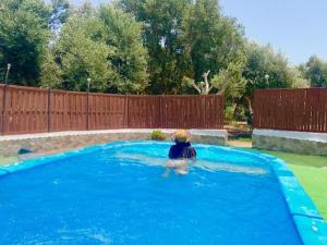 a person sitting in a swimming pool at Olive Oasis Adults only in Gran Tarajal