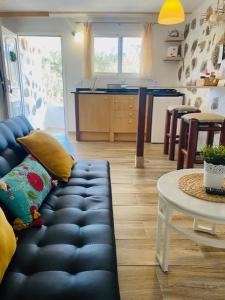 a living room with a blue couch and a table at Olive Oasis Adults only in Gran Tarajal