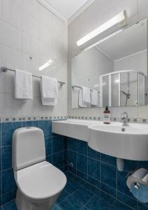 a bathroom with a sink and a toilet and a mirror at Osterøy Minihotell in Lonevåg +34 photos
