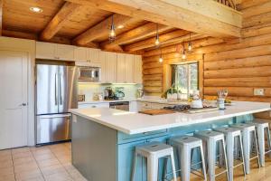 a kitchen with a large island with bar stools at Walk to Pine Mountain Lake: Spacious Family Cabin in Groveland