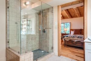 a bathroom with a walk in shower next to a bed at Walk to Pine Mountain Lake: Spacious Family Cabin in Groveland +37 photos