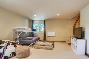 a bedroom with a bunk bed and a tv at Walk to Pine Mountain Lake: Spacious Family Cabin in Groveland