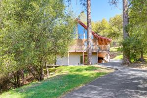 a house with a deck on the side of a road at Walk to Pine Mountain Lake: Spacious Family Cabin in Groveland