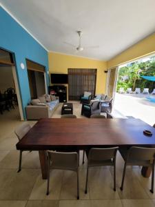 a living room with a wooden table and chairs at B&B Pavillion in Sosúa