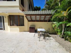 a patio with chairs and a table in front of a building at B&B Pavillion in Sosúa