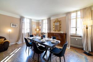 a dining room with a table with chairs and a mirror at Volto Santo - Sacred Residence - Piazza Maggiore in Bologna +38 photos