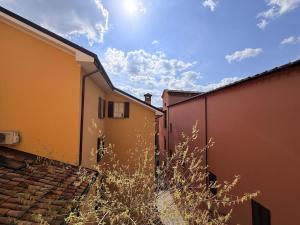 an alley between two buildings with the sky in the background at Volto Santo - Sacred Residence - Piazza Maggiore in Bologna