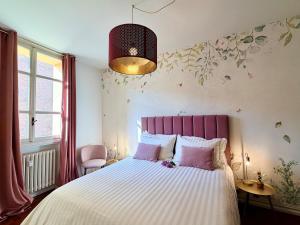 a bedroom with a large bed with a pink headboard at Volto Santo - Sacred Residence - Piazza Maggiore in Bologna