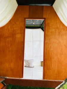 an open door to a bathroom with a toilet at Hanging Nest Salkantay in Colcapampa