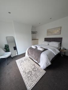 a bedroom with a large bed and a mirror at Entire Home in Denton in Denton