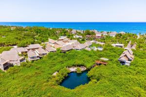 an aerial view of a house on a hill next to the ocean at Casa Teka - Boutique Hotel & Cenote in Tulum