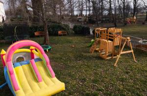 a park with a playground with a slide and a playset at Rittergut Dröschkau in Dröschkau