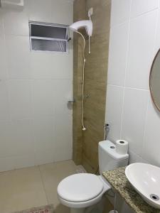 a bathroom with a toilet and a sink and a shower at Pousada le sorelle in Rosário do Sul +18 photos