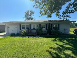 a house with a green lawn in front of it at 3 bed room lake cottage in Geneva