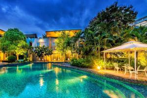 a swimming pool in front of a house at Paeva Luxury By Nakra Functionality in Bang Bo
