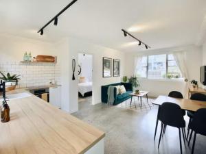 a living room with a couch and a table at Cronulla beach apartments in Cronulla