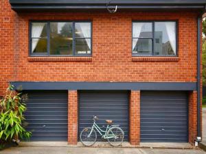 a bike parked in front of a garage at Cronulla beach apartments in Cronulla