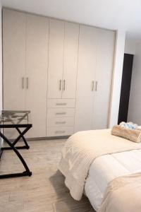 a bedroom with a bed and a glass table at Quiet Private Room in El Pueblito +8 photos