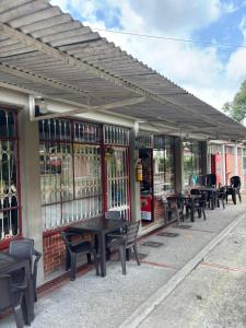 a row of tables and chairs outside of a building at Acogedor apartamento en Anapoima in Anapoima