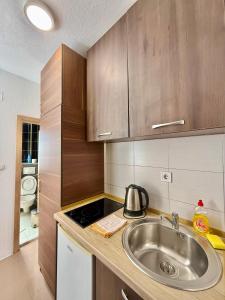 a kitchen with a sink and a counter top at Beachfront Bliss in Đenovići
