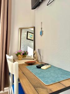 a dining room table with a mirror and a blue rug at Beachfront Bliss in Đenovići