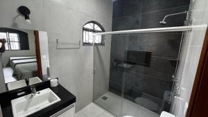 a bathroom with a shower and a sink and a shower at Casa Aparecida in Uberlândia +10 photos