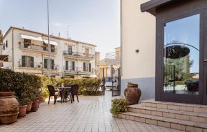 a patio with a table and chairs and buildings at Hotel Rossi in Manciano